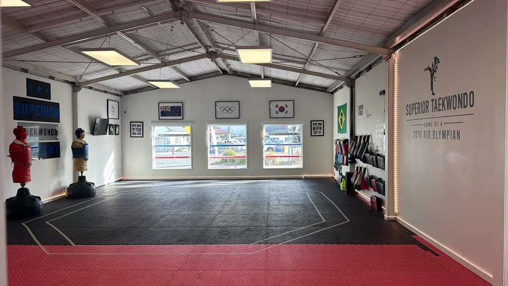 Students training on the mat inside the Superior Taekwondo dojang in Helensville